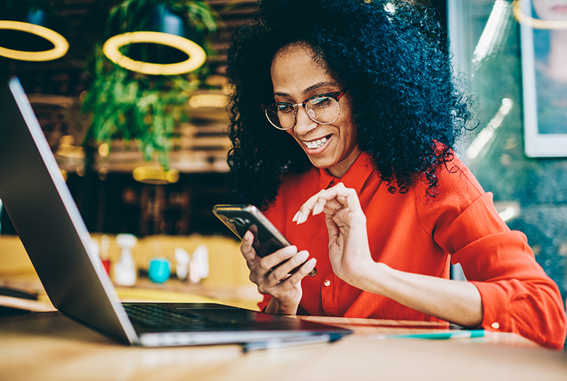 woman with phone and laptop